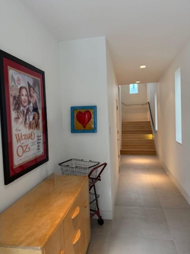 hall featuring recessed lighting, stairway, baseboards, and light tile patterned floors