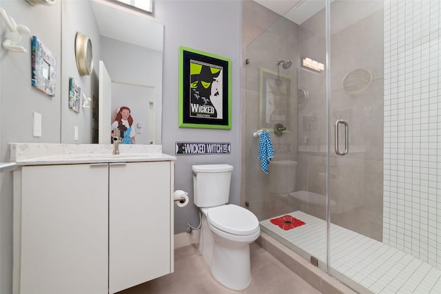 bathroom with vanity, a shower stall, toilet, and tile patterned floors