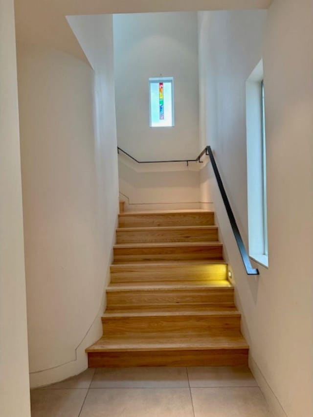 stairway with tile patterned floors