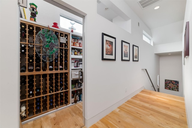 wine cellar with visible vents, wood finished floors, and recessed lighting