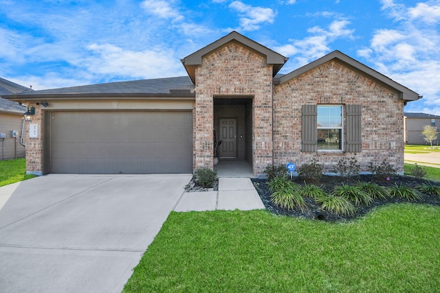 ranch-style home featuring a garage, a front yard, concrete driveway, and brick siding