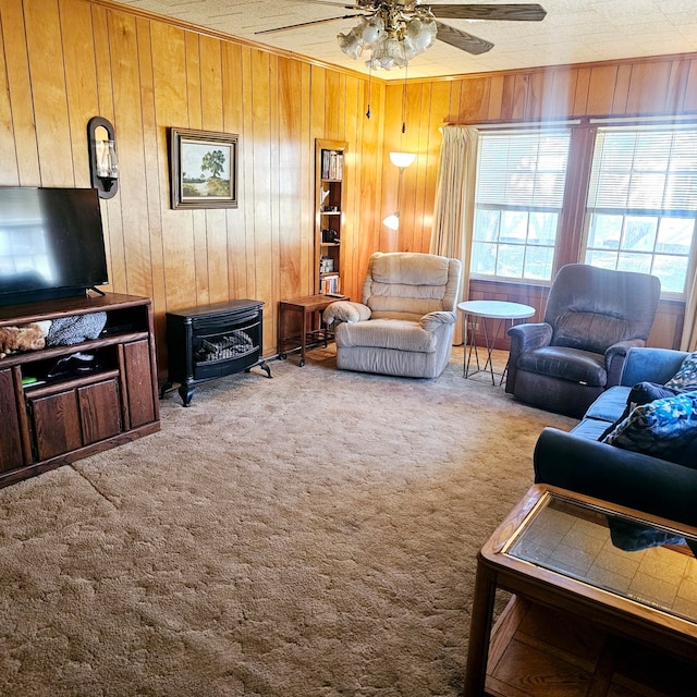 carpeted living room featuring a ceiling fan and wooden walls