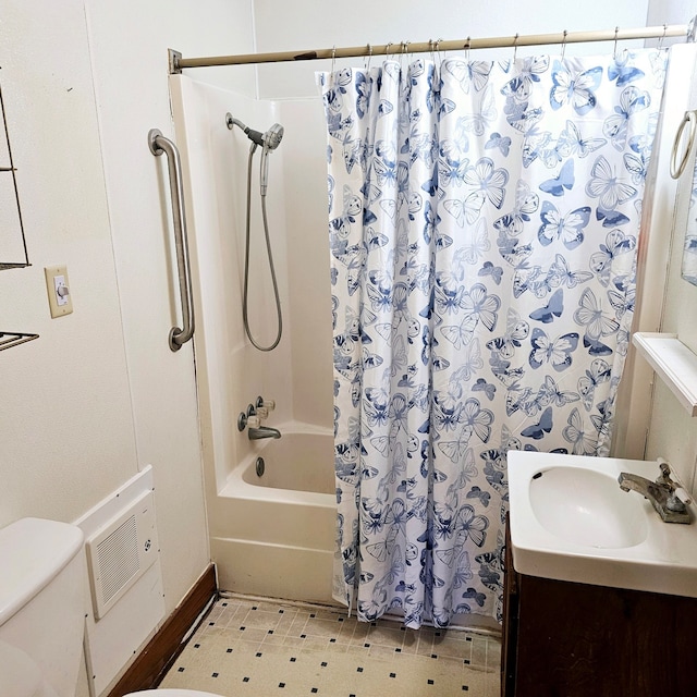 bathroom with vanity, shower / bath combination with curtain, and toilet