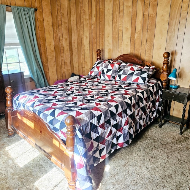 carpeted bedroom with wooden walls