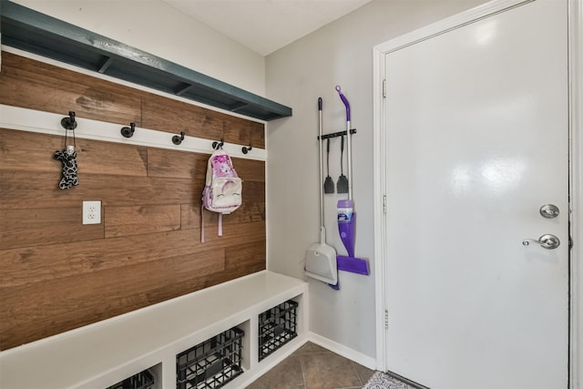 mudroom featuring wooden walls