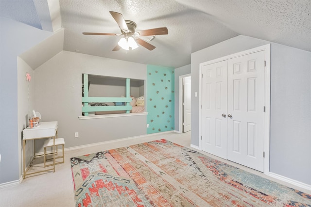 1731 Red Oak Ter, Houston, TX 77339 - carpeted bedroom featuring lofted ceiling, a textured ceiling, a closet, and a ceiling fan