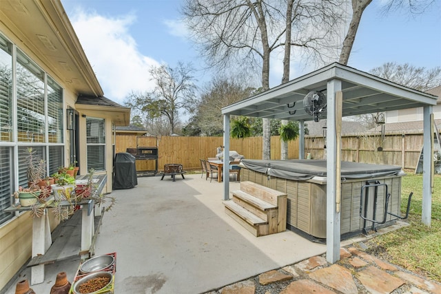 view of patio / terrace featuring a gazebo, a fenced backyard, and a hot tub