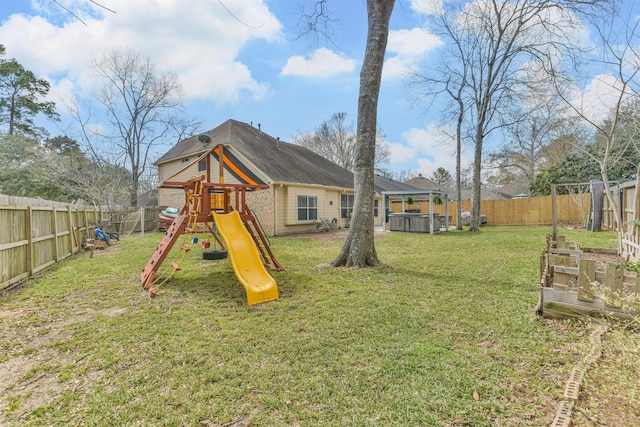 view of jungle gym with a lawn, a fenced backyard, and a jacuzzi