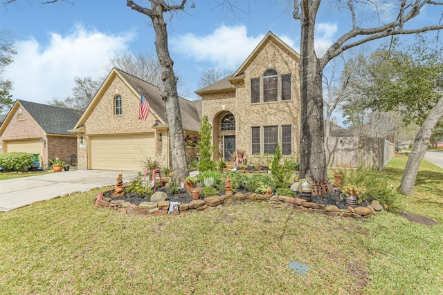 traditional home featuring driveway, a front yard, and brick siding