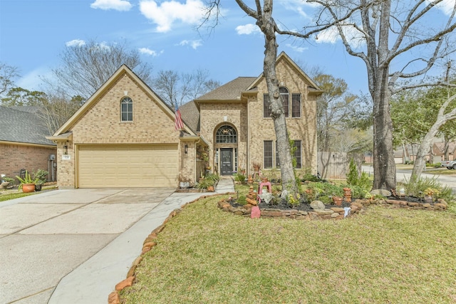 view of front of property featuring a garage, a front yard, brick siding, and driveway