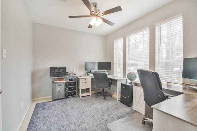 home office featuring ceiling fan and baseboards