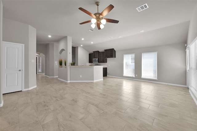 unfurnished living room featuring baseboards, visible vents, and a ceiling fan