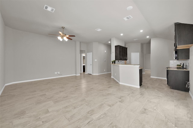 unfurnished living room with vaulted ceiling, visible vents, ceiling fan, and baseboards