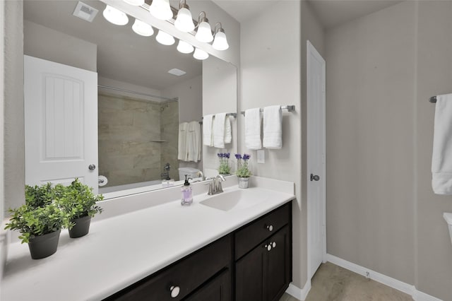 full bath featuring toilet, vanity, visible vents, and baseboards