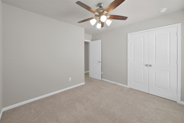 unfurnished bedroom with a ceiling fan, a closet, carpet flooring, and baseboards