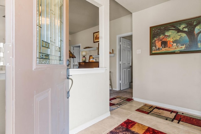 foyer entrance with baseboards and tile patterned floors