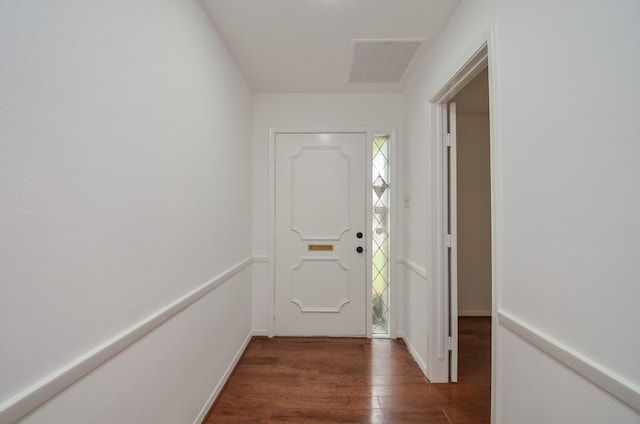 doorway featuring dark wood-type flooring and visible vents