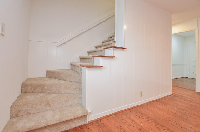 stairs featuring wood finished floors