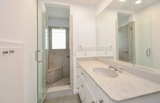 full bath with vanity, tile patterned floors, and a shower stall