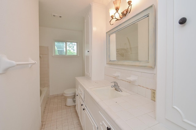 bathroom with vanity, toilet, decorative backsplash, walk in shower, and visible vents