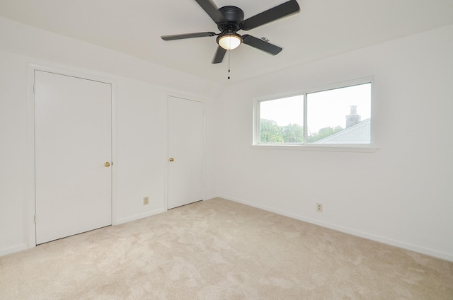 unfurnished bedroom featuring carpet floors, baseboards, and ceiling fan