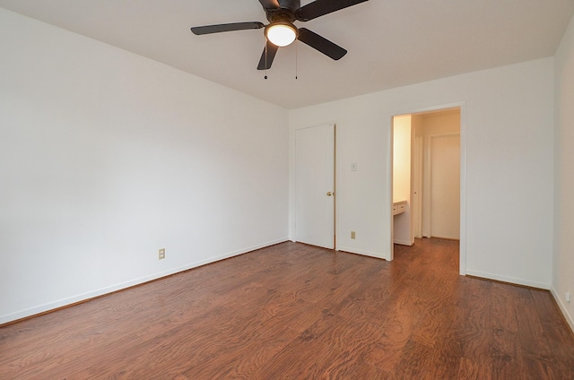 unfurnished room with baseboards, wood finished floors, and a ceiling fan