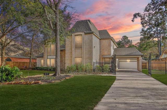 view of front of home with fence, a lawn, and brick siding