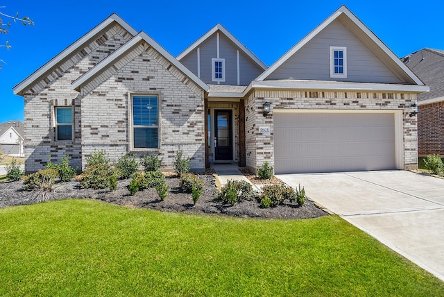 view of front facade featuring brick siding, a garage, driveway, and a front lawn