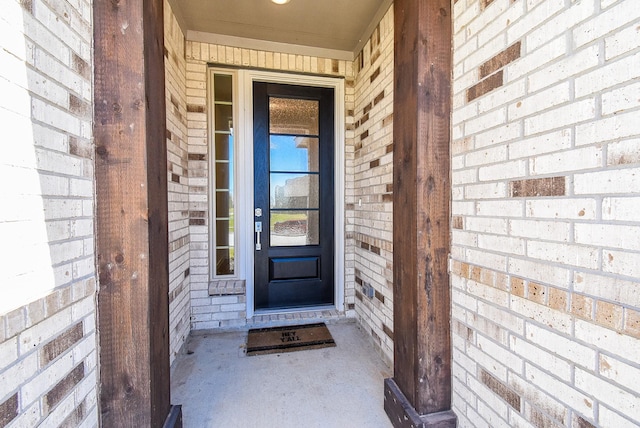 property entrance featuring brick siding