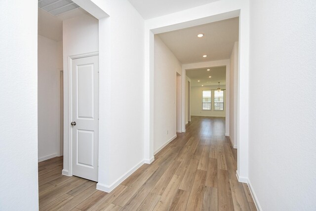 corridor featuring recessed lighting, baseboards, and light wood-style flooring