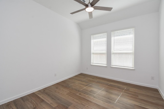 unfurnished room featuring lofted ceiling, wood finished floors, baseboards, and ceiling fan