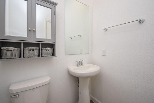 bathroom featuring toilet and a sink