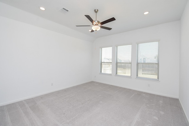 spare room featuring recessed lighting, baseboards, visible vents, and light carpet