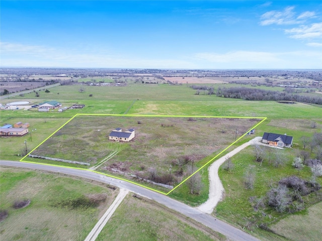 birds eye view of property with a rural view