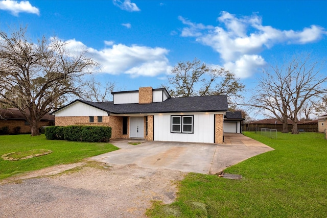 608 Roene Ln, Brazoria, TX 77486 - view of front of house featuring concrete driveway, a front lawn, a garage, and a shingled roof