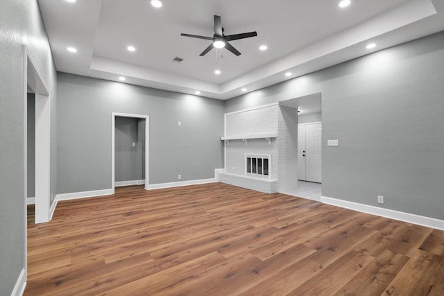 unfurnished living room featuring a fireplace, baseboards, and recessed lighting