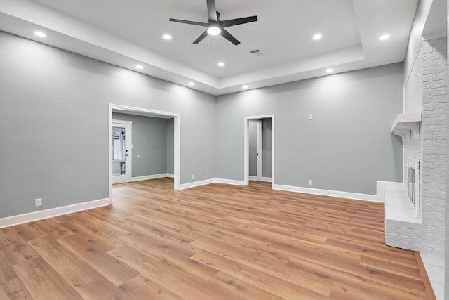 unfurnished living room with recessed lighting, a fireplace, visible vents, and light wood-style floors