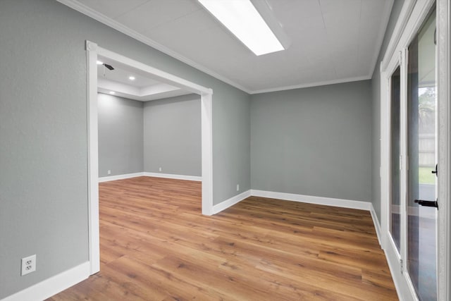 interior space featuring baseboards, ornamental molding, wood finished floors, and recessed lighting