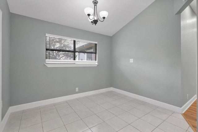 unfurnished room featuring lofted ceiling, baseboards, and a chandelier