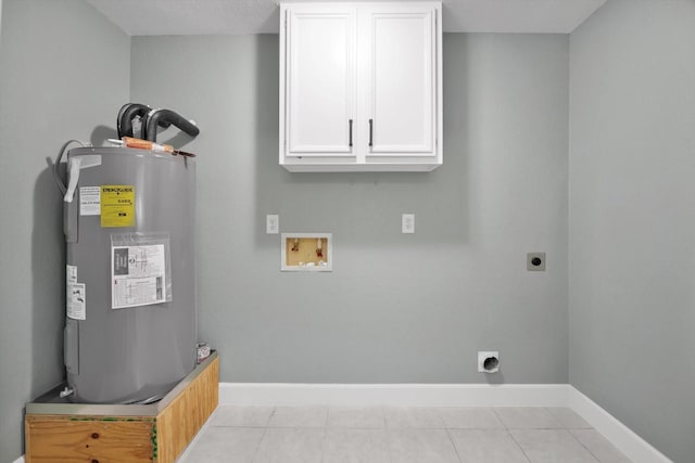 clothes washing area featuring hookup for a washing machine, cabinet space, electric water heater, electric dryer hookup, and baseboards