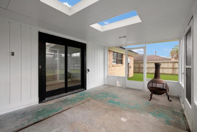 unfurnished sunroom with a skylight