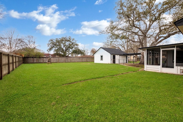 view of yard featuring a fenced backyard and a sunroom