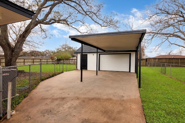 exterior space featuring an outbuilding, a detached garage, and fence