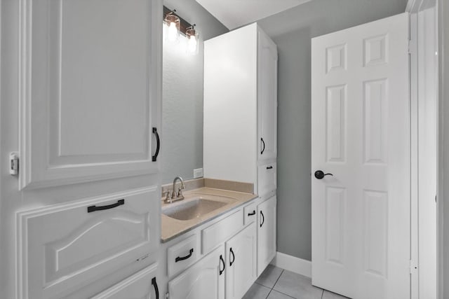 bathroom with tile patterned flooring, vanity, and baseboards