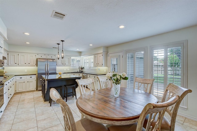 dining room with light tile patterned flooring, visible vents, and recessed lighting