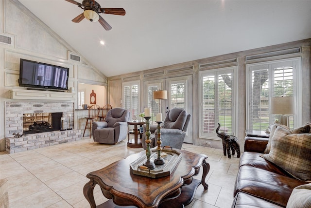 living area with high vaulted ceiling, light tile patterned flooring, a brick fireplace, and visible vents