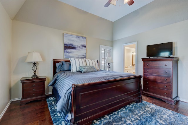 bedroom featuring vaulted ceiling, connected bathroom, hardwood / wood-style flooring, and baseboards