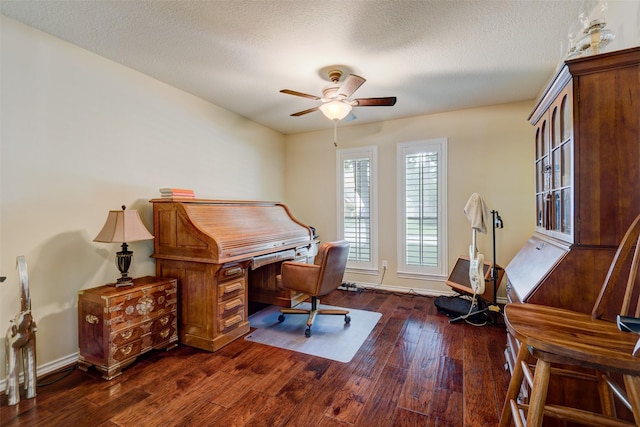 home office featuring dark wood-style floors, a textured ceiling, a ceiling fan, and baseboards