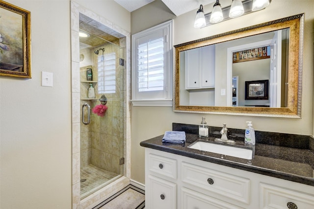 bathroom with a stall shower and vanity