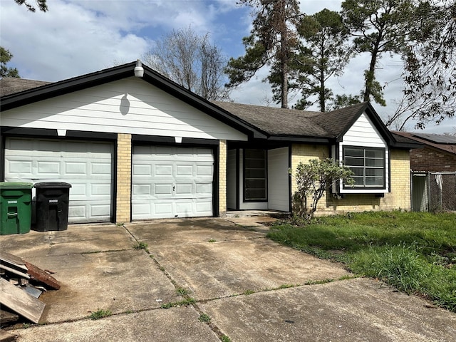 ranch-style home with concrete driveway, brick siding, an attached garage, and roof with shingles